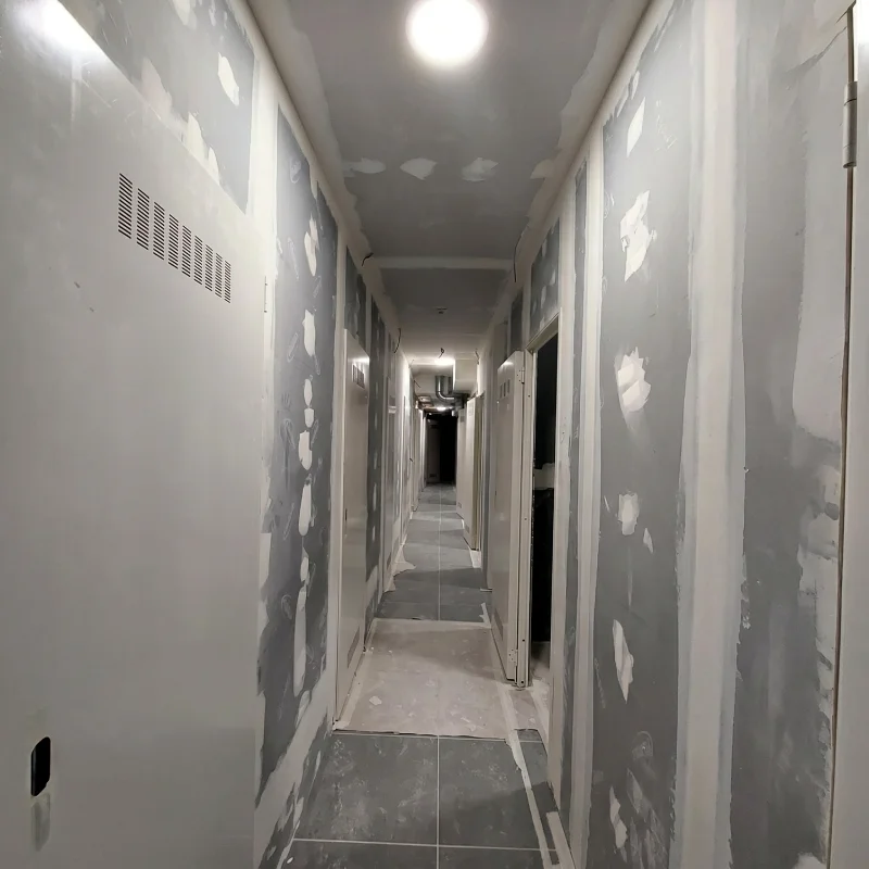 Pasillo de trasteros terminados con sistemas de tabiquería seca de alta resistencia Placa Habito